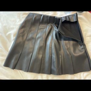 Black leather pleated mini skirt